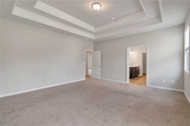 2320 Ivy Birch Ln, Buford, GA 30519 - unfurnished bedroom with a raised ceiling, light carpet, baseboards, and ensuite bathroom