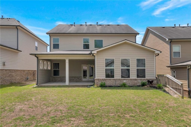 2320 Ivy Birch Ln, Buford, GA 30519 - back of house featuring a patio, brick siding, and a lawn