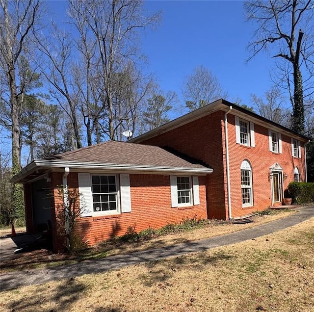 view of side of home featuring brick siding