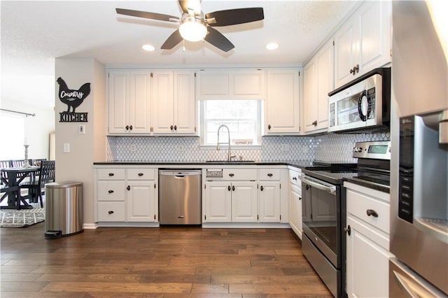 89 Paul Cir, Jasper, GA 30143 - kitchen with appliances with stainless steel finishes, dark countertops, ceiling fan, dark wood-type flooring, and recessed lighting