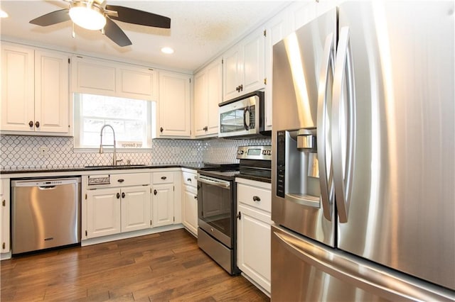 89 Paul Cir, Jasper, GA 30143 - kitchen featuring stainless steel appliances, dark countertops, recessed lighting, white cabinets, and decorative backsplash