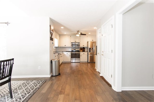 89 Paul Cir, Jasper, GA 30143 - kitchen with appliances with stainless steel finishes, dark wood finished floors, a ceiling fan, tasteful backsplash, and recessed lighting