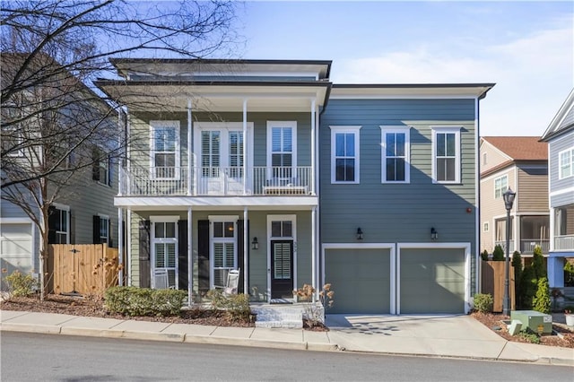 view of front of property featuring a garage and a balcony