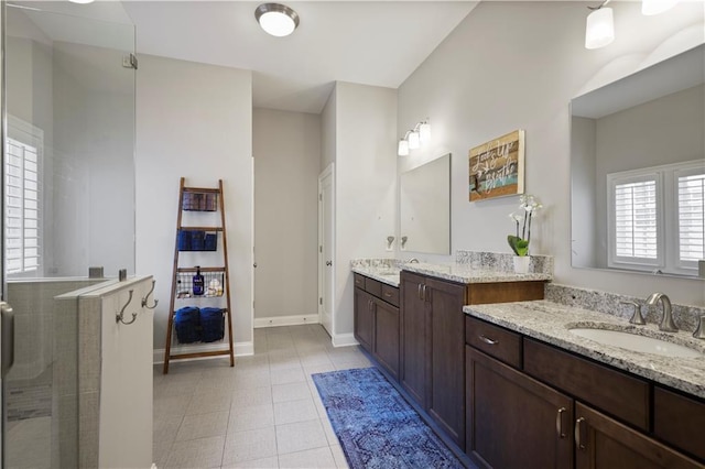 bathroom with an enclosed shower, vanity, and tile patterned floors