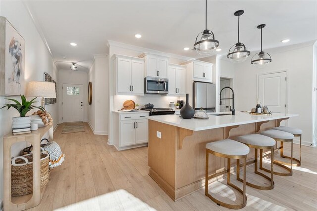 432 Carrera Ln, Acworth, GA 30102 - kitchen featuring stainless steel appliances, ornamental molding, a sink, and an island with sink