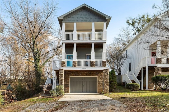 view of front of property with a front yard, a balcony, and a garage