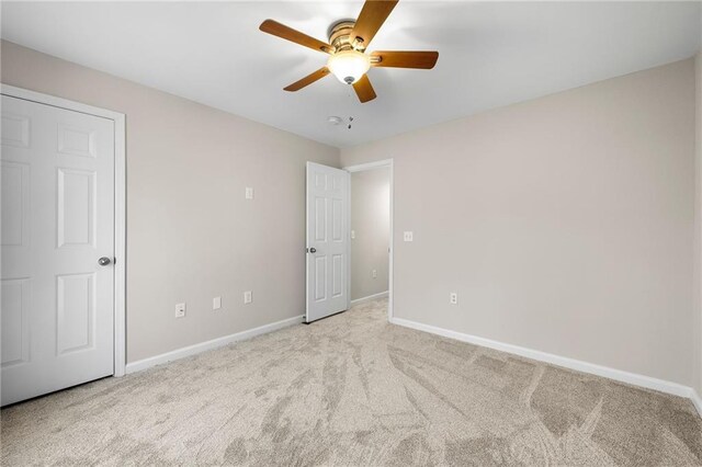 unfurnished bedroom with ceiling fan and light carpet