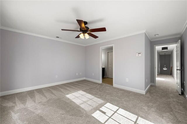 unfurnished bedroom featuring light carpet, ceiling fan, and ornamental molding