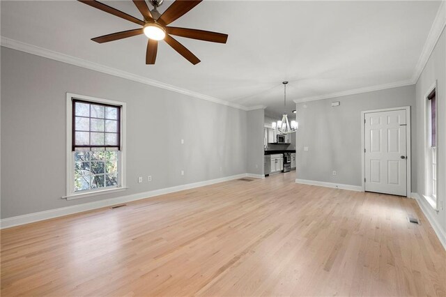 unfurnished living room with ceiling fan with notable chandelier, light wood-type flooring, and crown molding