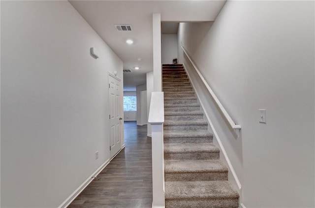 staircase with wood-type flooring