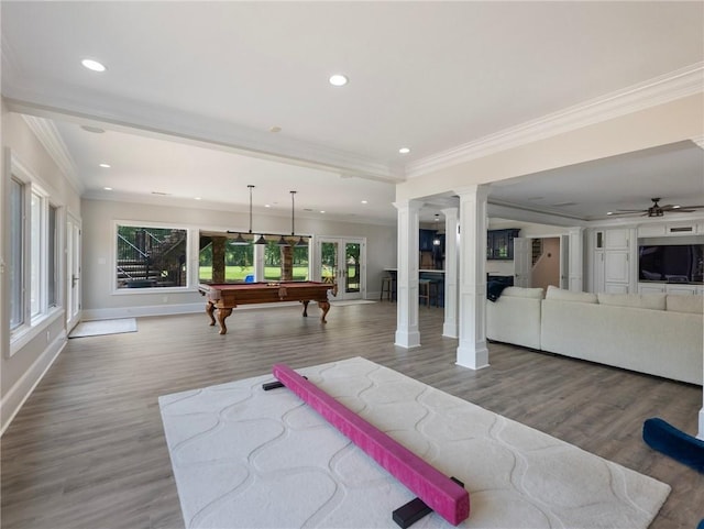 game room with decorative columns, ornamental molding, hardwood / wood-style floors, and billiards