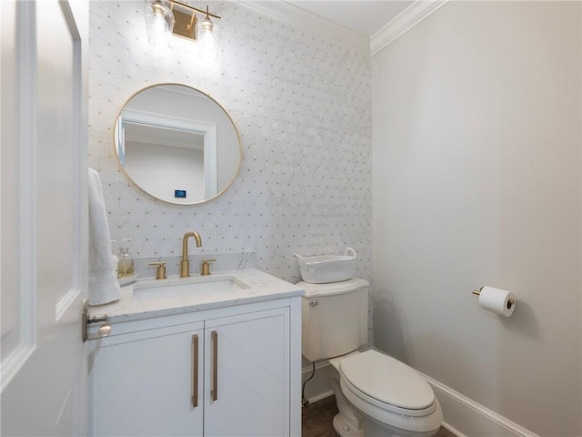 bathroom featuring vanity, crown molding, and toilet