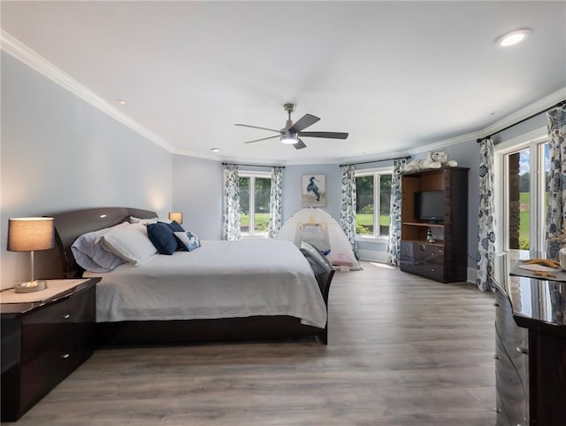 bedroom with hardwood / wood-style flooring, ceiling fan, and ornamental molding