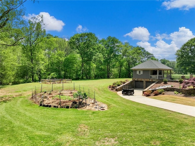 view of yard with a garage and a rural view