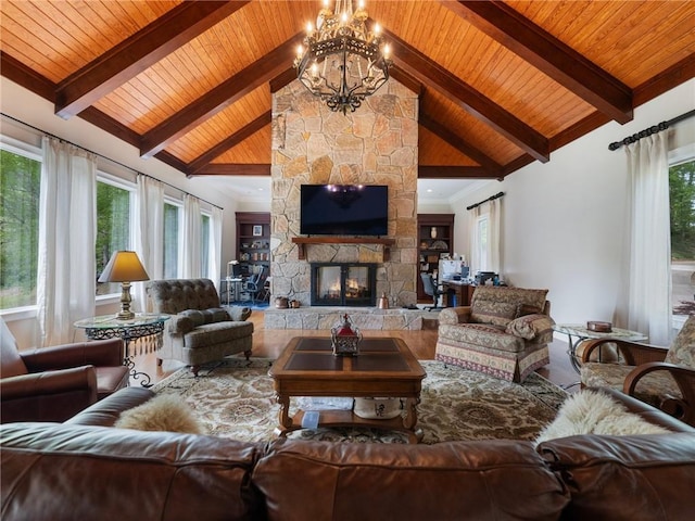 living room featuring an inviting chandelier, beamed ceiling, a stone fireplace, and wooden ceiling