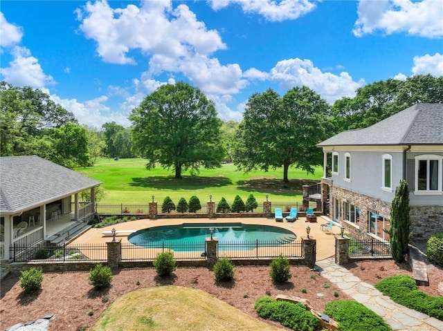 view of pool featuring a yard and a patio area