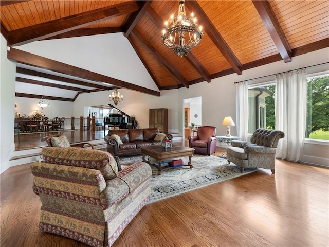 living room with hardwood / wood-style floors, beam ceiling, and a chandelier