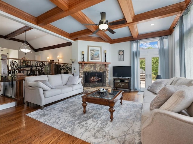 living room featuring hardwood / wood-style floors, a fireplace, coffered ceiling, beam ceiling, and french doors