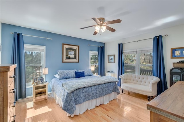 bedroom with ceiling fan and light wood-style flooring