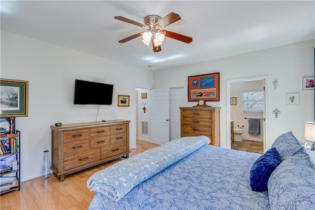 bedroom with visible vents, light wood-style flooring, a ceiling fan, ensuite bathroom, and baseboards