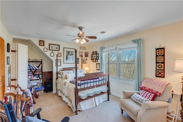 bedroom featuring baseboards, light colored carpet, visible vents, and ceiling fan