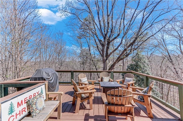 wooden terrace with an outdoor fire pit