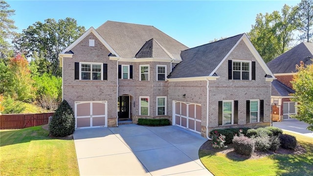 view of front of property featuring a garage and a front lawn