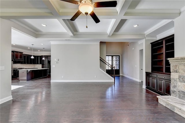 unfurnished living room featuring ceiling fan, beam ceiling, coffered ceiling, ornamental molding, and dark hardwood / wood-style flooring