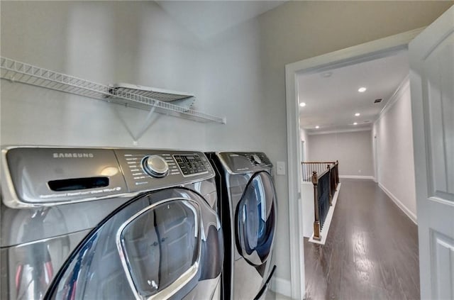 laundry area featuring dark hardwood / wood-style flooring and washing machine and dryer