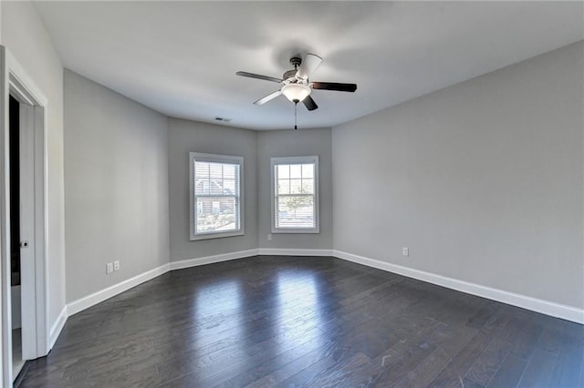 spare room featuring dark wood-type flooring and ceiling fan