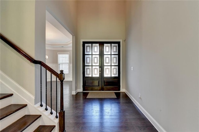 entrance foyer with dark hardwood / wood-style flooring and french doors