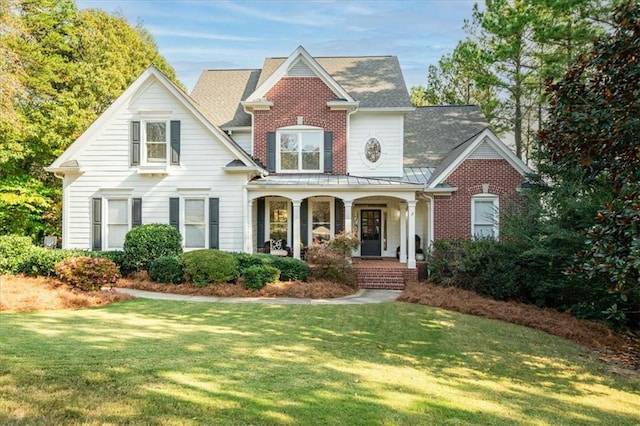 view of front of house with covered porch and a front yard