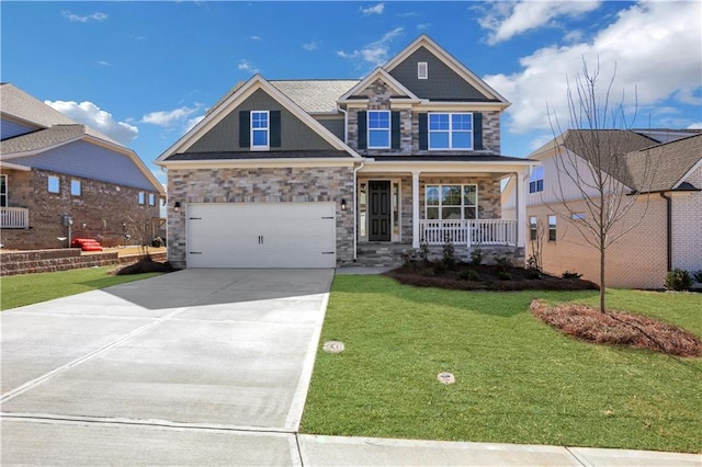 craftsman inspired home with a front lawn, covered porch, stone siding, and concrete driveway