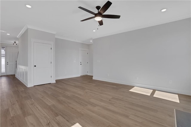 unfurnished living room featuring ornamental molding, recessed lighting, and light wood-style floors