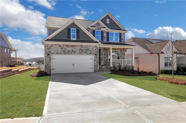 craftsman inspired home featuring a porch, concrete driveway, stone siding, and a front lawn