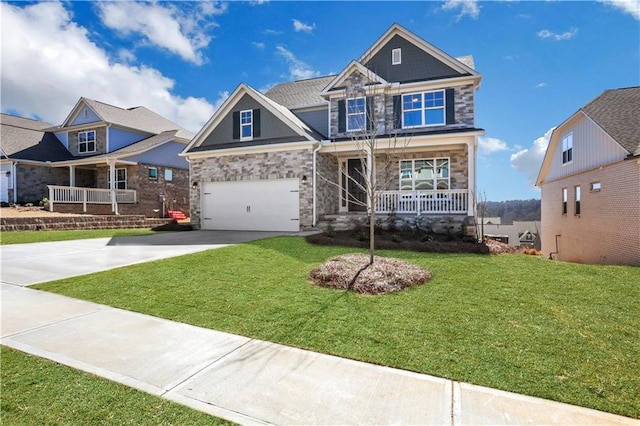 craftsman inspired home with stone siding, a porch, a front yard, and driveway