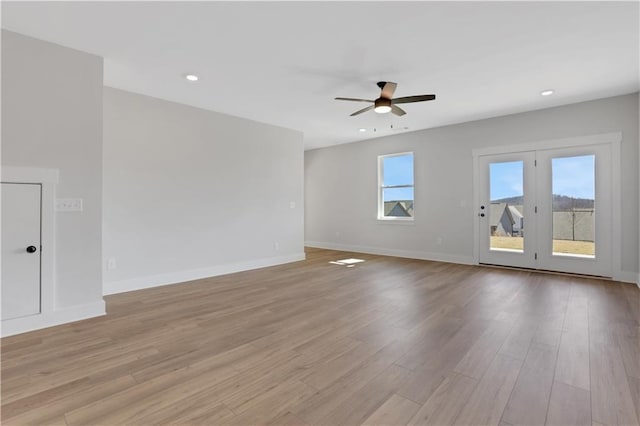 unfurnished living room featuring a ceiling fan, light wood-type flooring, baseboards, and recessed lighting