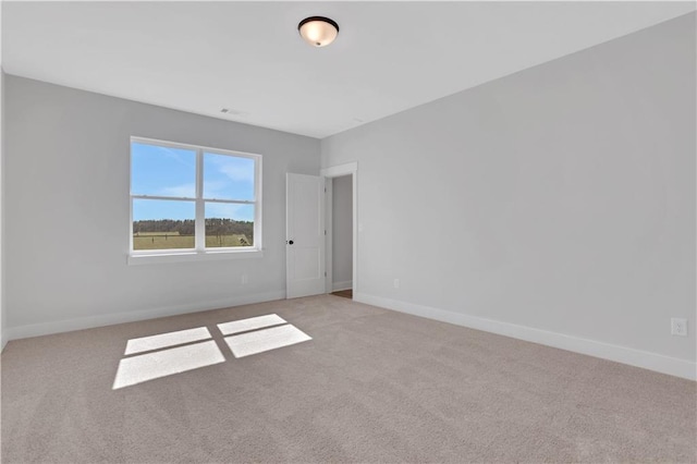 empty room with light carpet and baseboards