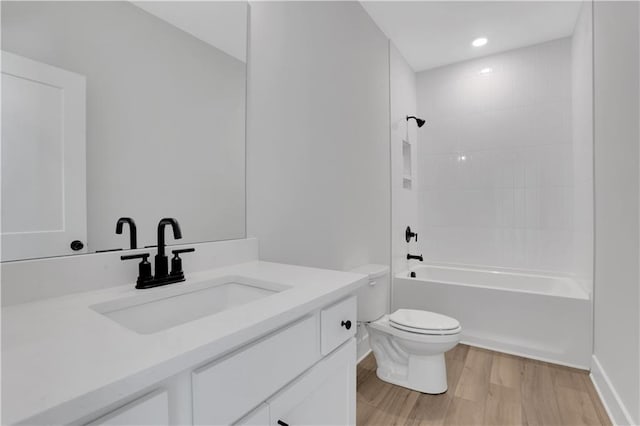 full bathroom with tub / shower combination, vanity, toilet, and wood finished floors