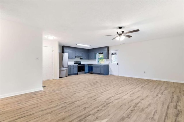 unfurnished living room with baseboards and light wood-style floors