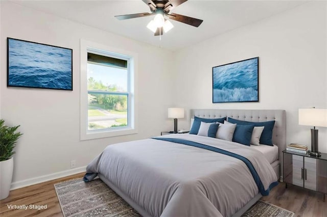 bedroom with wood finished floors, baseboards, and ceiling fan