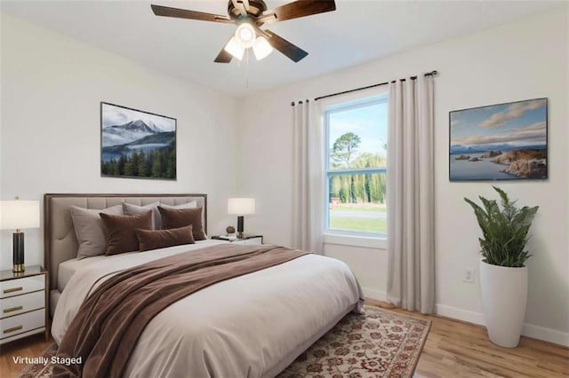 bedroom with wood finished floors, baseboards, and ceiling fan