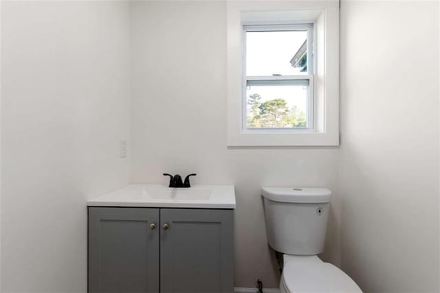 bathroom featuring toilet and vanity