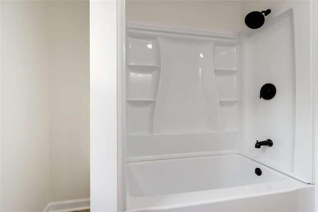 full bathroom featuring baseboards and washtub / shower combination