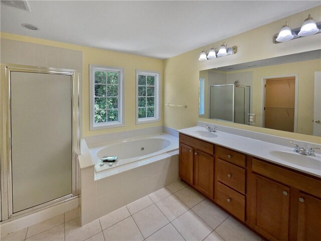 bathroom with a sink, a shower stall, and tile patterned floors