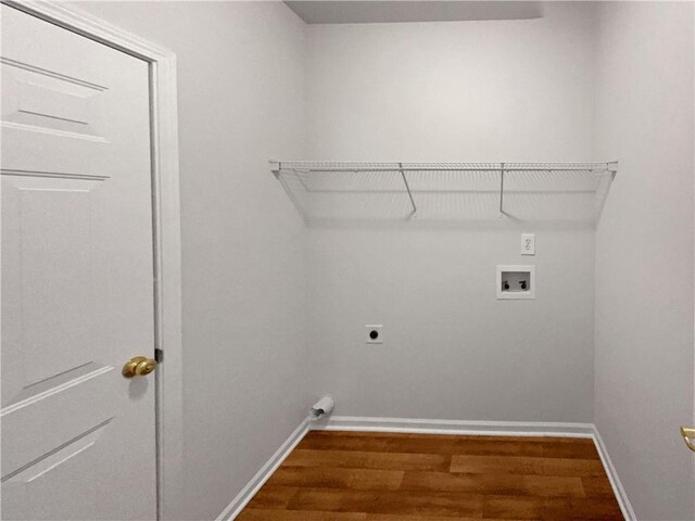 washroom featuring hookup for an electric dryer, laundry area, washer hookup, baseboards, and dark wood finished floors