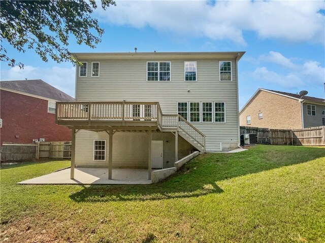 rear view of property with a patio, a fenced backyard, a yard, stairway, and a wooden deck