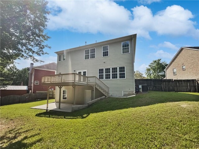 back of house featuring a fenced backyard, stairs, central AC, and a yard