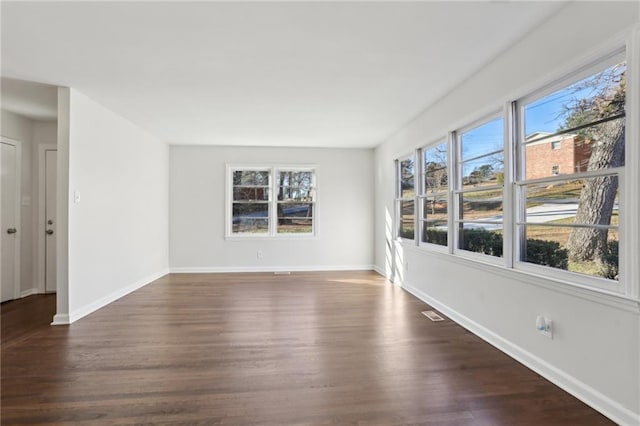 spare room featuring dark hardwood / wood-style flooring