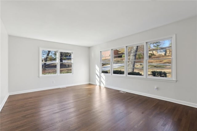 unfurnished room featuring dark hardwood / wood-style flooring